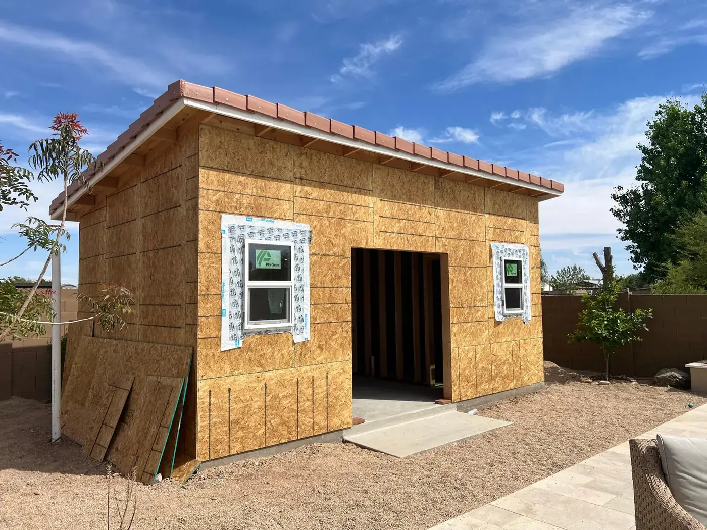 The casita sheathed in OSB with a tile roof and flashed windows installed.
