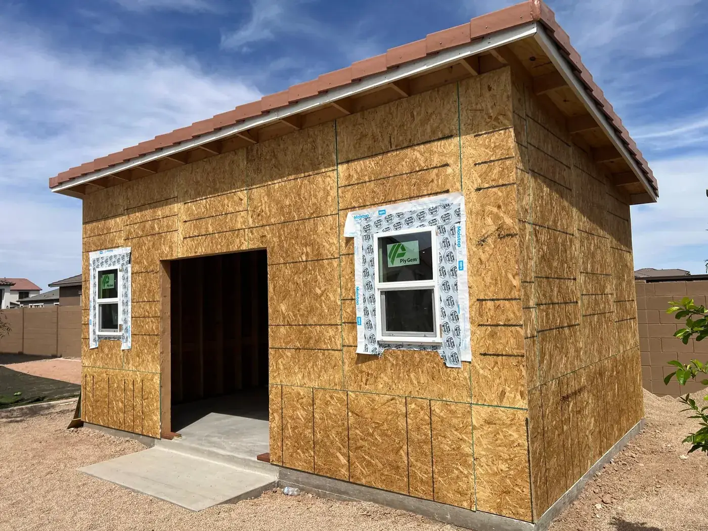Side of the sheathed casita with a taped and flashed window opening.