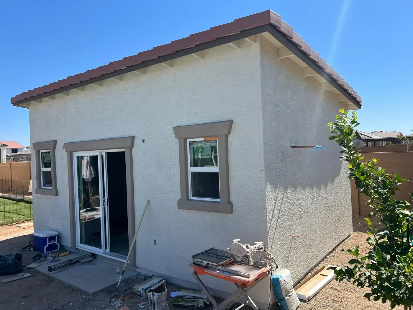 Rear elevation of the stuccoed casita showing shaped window surrounds.